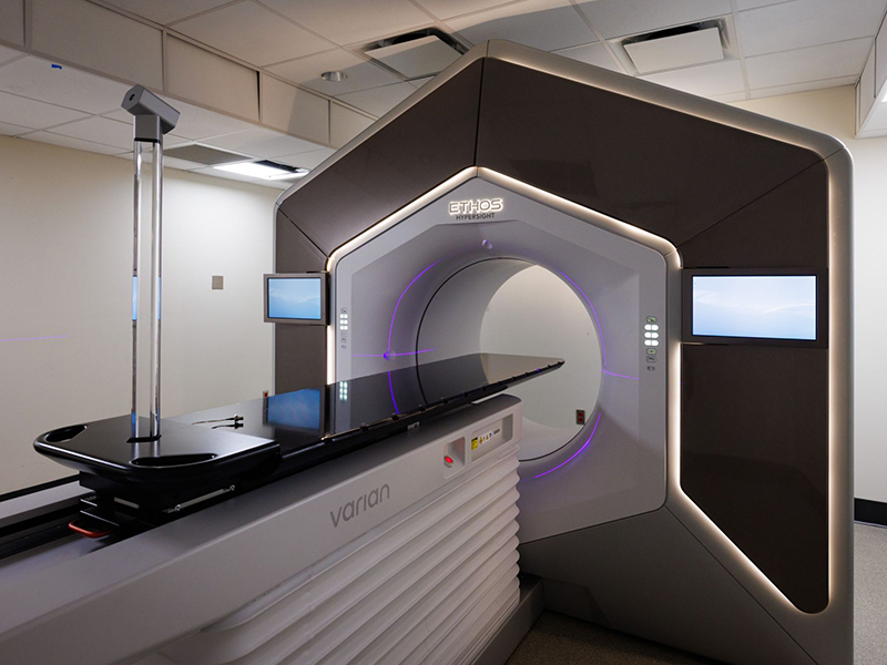 Angled view of the Varian Ethos Adaptive Radiotherapy System in a diagnostics room.